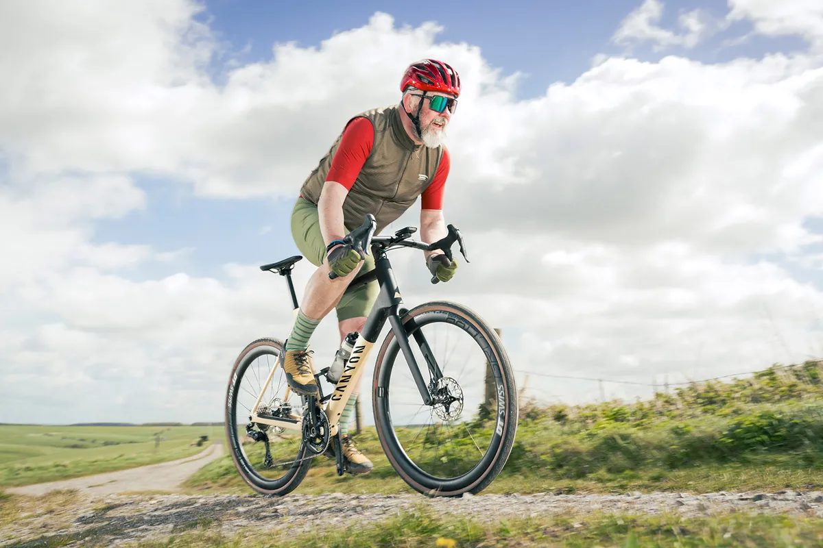 Male cyclist in red and khaki on a Canyon Grail CF SLX 8 Di2 gravel bike