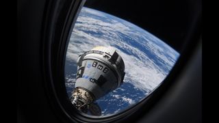 a gray-blue cone-shaped spaceship seen through a window with the earth below