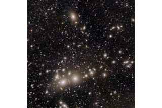 Image of lots of stars and galaxies in space.