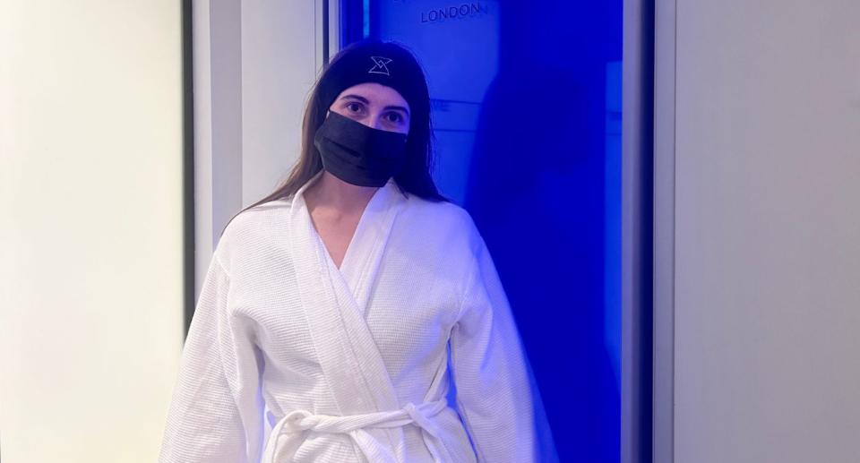 Standing in front of the cryotherapy chamber.  (Yahoo Life UK)