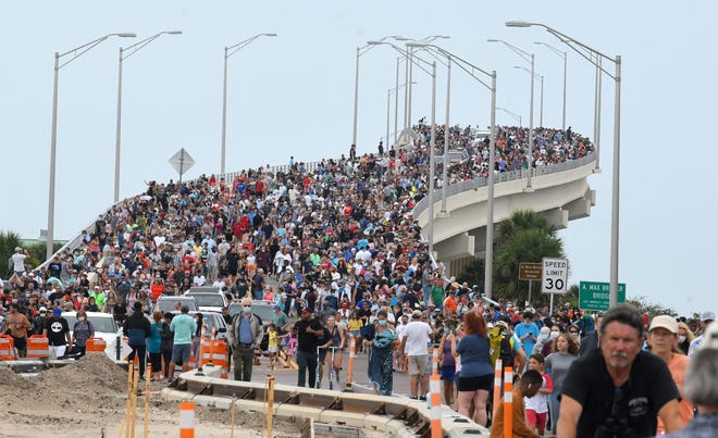 Huge crowds of launch spectators on the A. Max Brewer Bridge in Titusville return to their vehicles in May 2020 after viewing the historic flight of SpaceX Demo-2, America's first manned mission in nearly a decade.