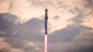 a large silver rocket flies through the golden morning sky