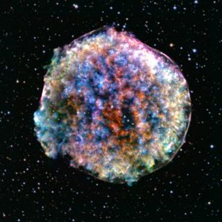 A blurred, multi-colored ball on the background of space, which is dotted with stars.