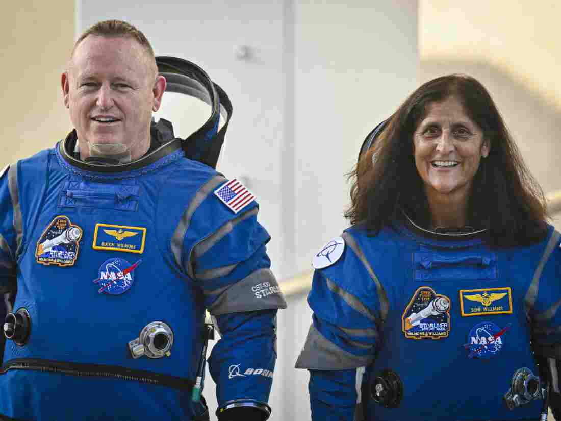 NASA astronauts Butch Wilmore (L) and Suni Williams in Boeing spacesuits as they leave the Operations and Treasury Building for the launch pad at the Kennedy Space Center in Florida on Wednesday.  This is the third journey into space for both of them.