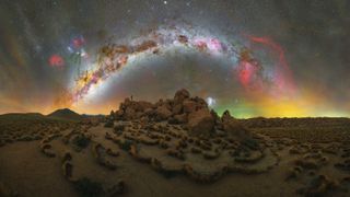 The arc of the Milky Way photographed over a pile of rocks in the Atacama Desert in Chile