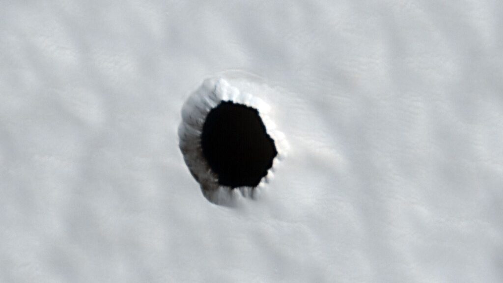 A white background with a black circle that appears to be a hole.