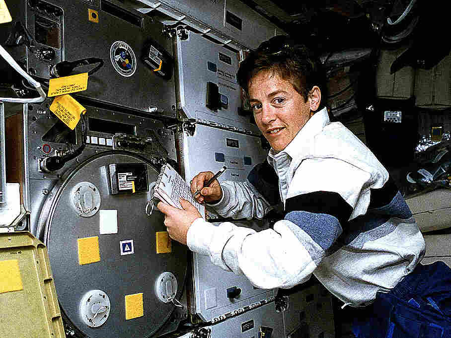 Astronaut Wendy B. Lawrence, STS-67 flight engineer and mission specialist, scribbles notes in the margin of a checklist while watching an experiment on the center deck of space shuttle Endeavour.