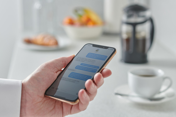 Man Using Smartphone In Kitchen