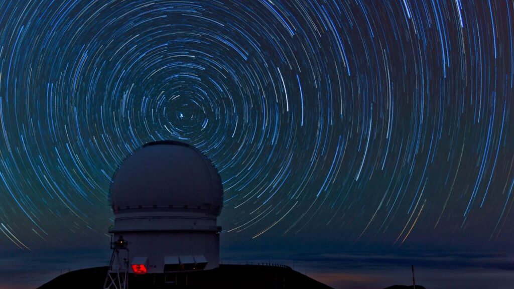 Stars spinning around an observatory in the night sky