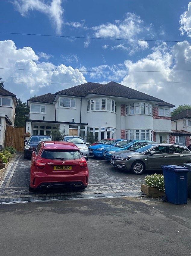 A paved front yard converted into a car dealership