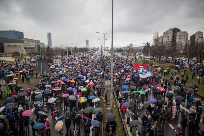 People gather to block a highway in Belgrade on December 11, 2021 to protest against Anglo-Australian company Rio Tinto's plan to open a lithium mine in the country