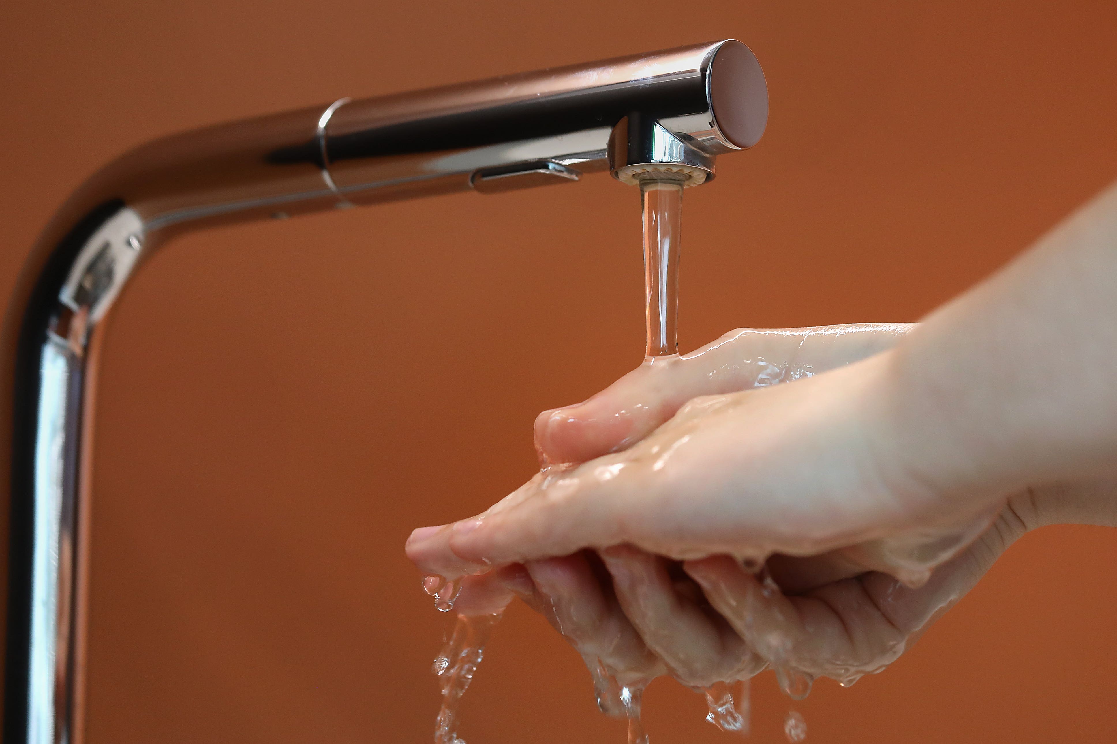 A man washes his hands under running water (Philip Toscano/PA)