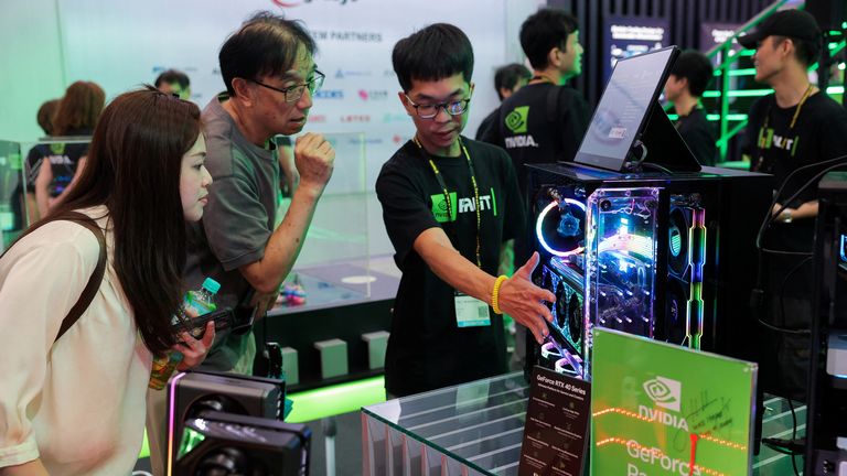 Workers present NVIDIA GeForce series devices on display at Computex in Taipei, Taiwan June 5, 2024. REUTERS/Ann Wang