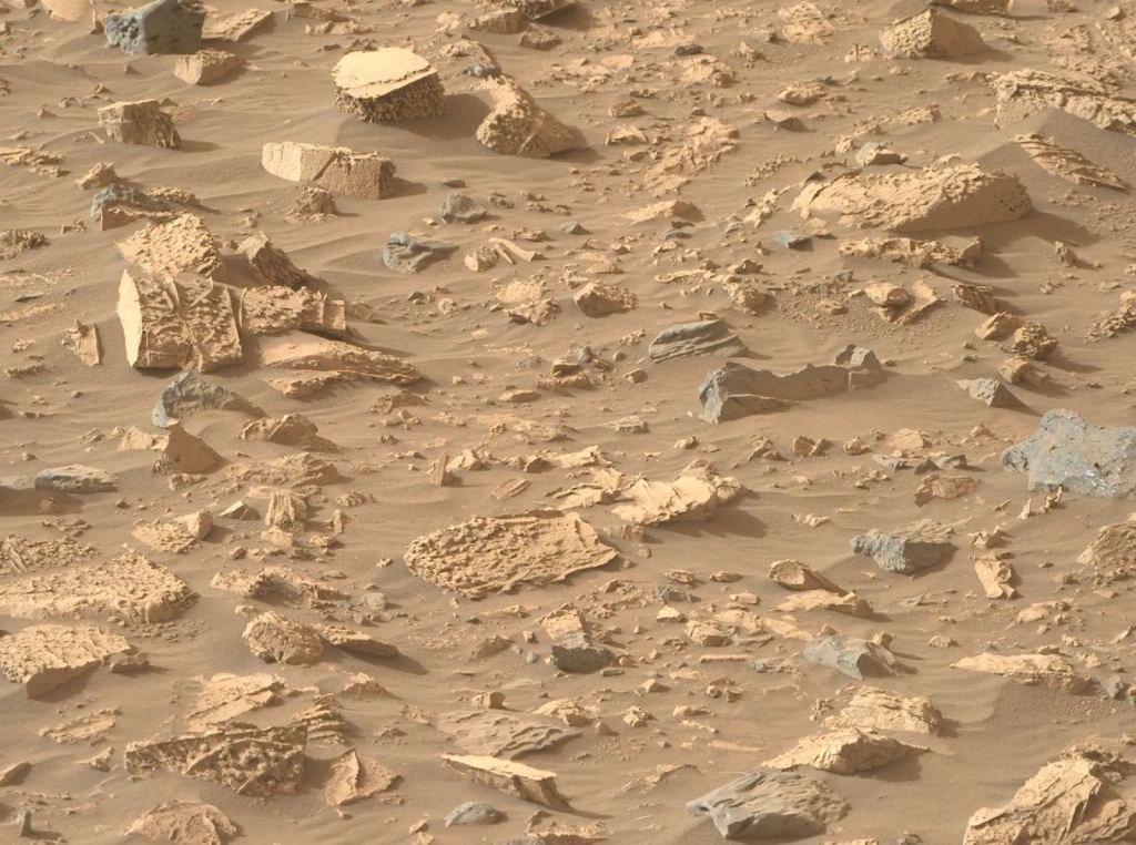 These rocks at Bright Angel have unusual popcorn-like textures and rich mineral veins.  Image credit: NASA/JPL-Caltech/ASU