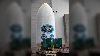 large white cylinder with nasa logo and insignia lettering 