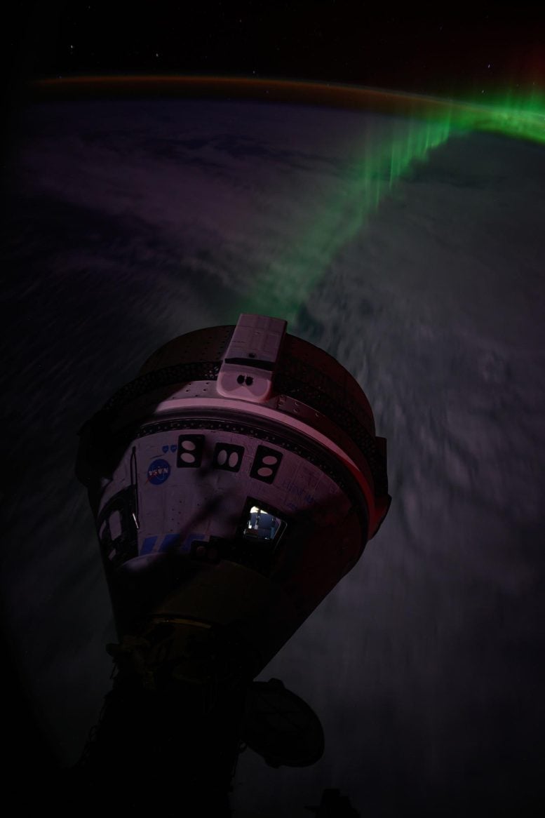 The aurora flows beneath Boeing's Starliner spacecraft