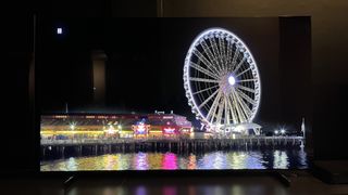 TCL QM851G TV displaying a ferris wheel image