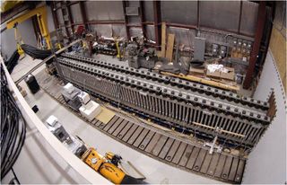 a long metal rail above a row of rectangular magnets inside the hangar