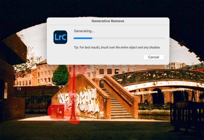 The photo editing software interface displays an overlay with a progress bar and words "Generating..." indicating item removal.  The background image shows a wall covered in graffiti, a bridge and a city scene with buildings.