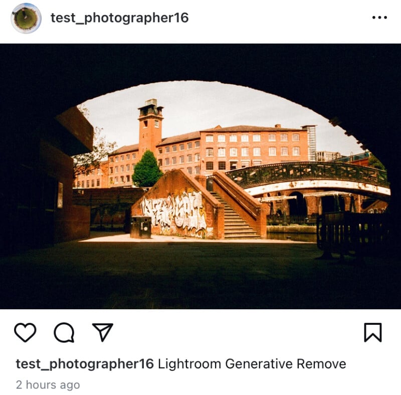 View of the brick building and clock tower across the canal, framed by a dark arch.  A red bridge spans the canal and graffiti can be seen on the brick wall.  The photo caption reads, "test_photographer16 Generative removal of Lightroom.