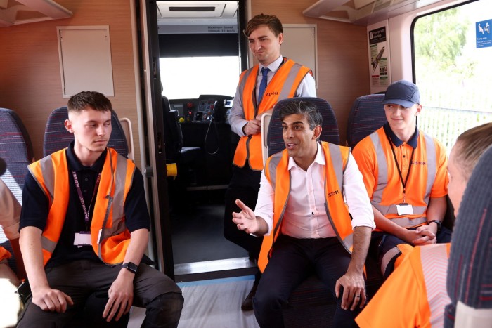 British Prime Minister and Conservative Party leader Rishi Sunak speaks to apprentices on the new train during a visit to Alstom Transport in Derby