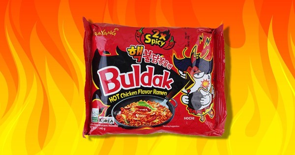 Buldak spicy noodles on a fiery background.