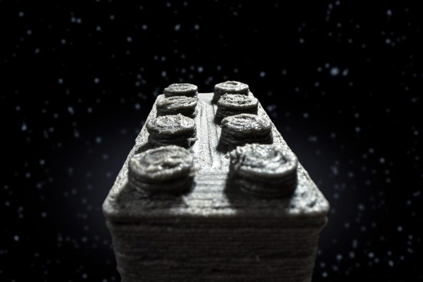 Composite image of a close-up of a 3D printed Lego-style brick that appears to be flying through space