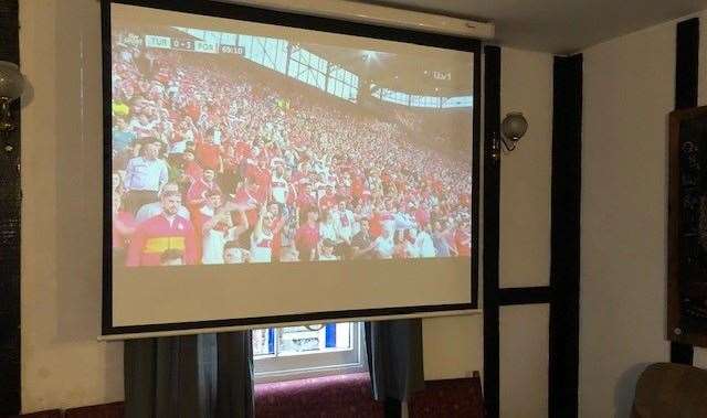 There was no one there to see it, but the projection screen at the back of the pub was showing football