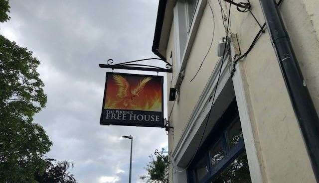 The pub's crest, proud of a single house, was a very impressive sign