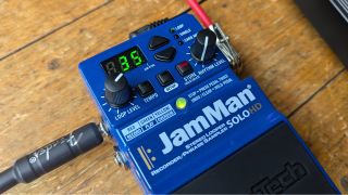 The front panel of the DigiTech JamMan looper pedal plugged into the pedalboard