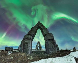 The aurora borealis in the shape of a kite over the arctic henge.