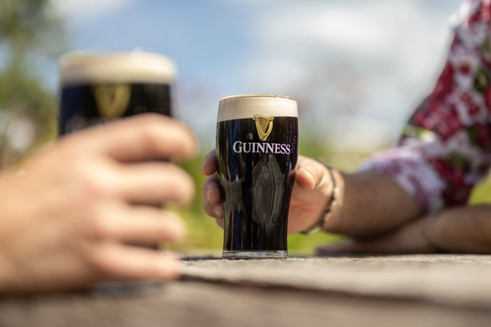 Customers drink pints of Guinness at a pub in Sussex