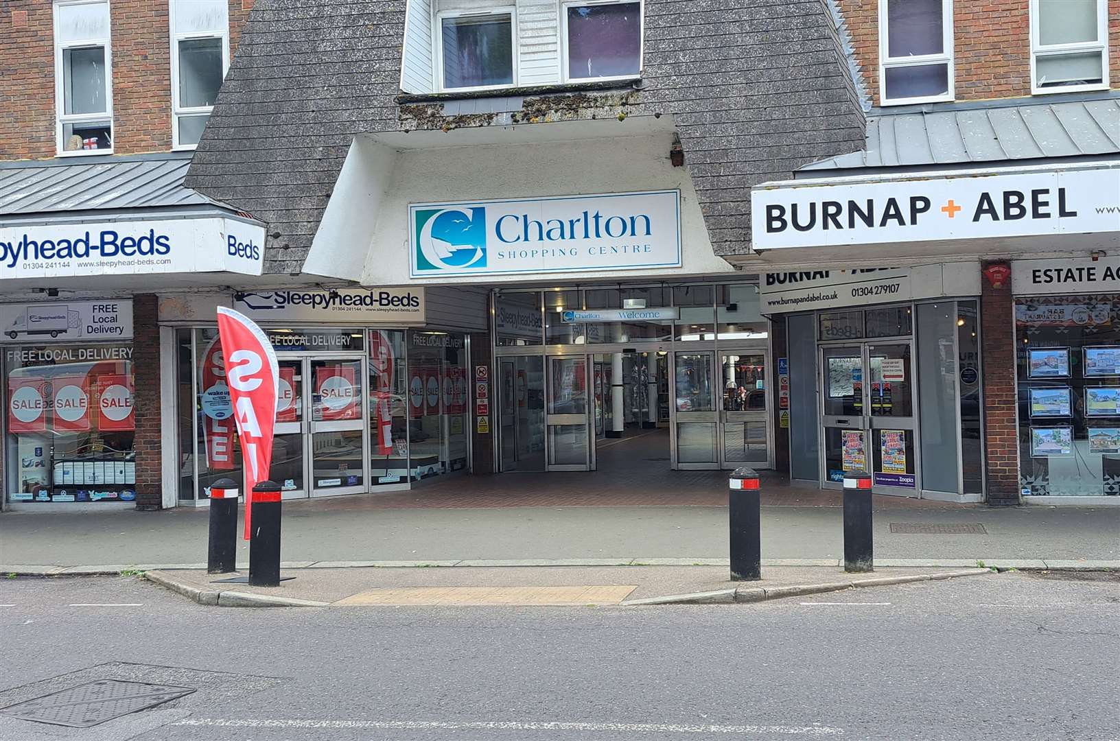 The main entrance to Charlton Shopping Center in Dover and its two businesses