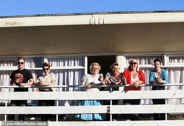 A group of enthusiasts on a cottage balcony at the Rockabilly Weekend at Pontins, Camber Sands, East Sussex, in June 2013