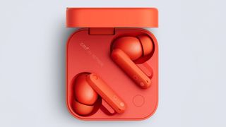 Orange pair of CMF by Nothing Buds Pro 2 wireless headphones in a case