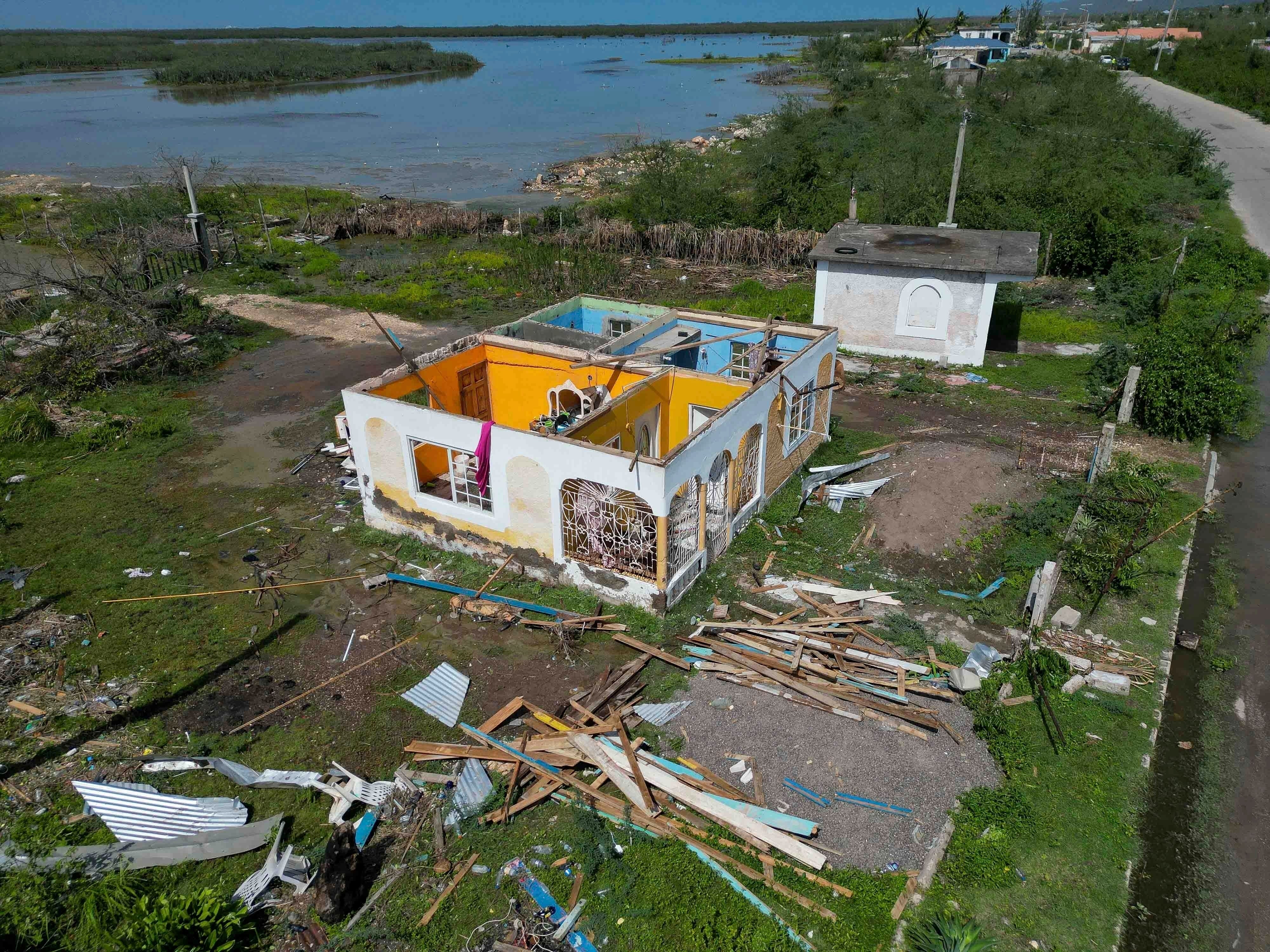 A house stands without a roof after being damaged by Hurricane Beryl in Portland Cottage, Clarendon, Jamaica