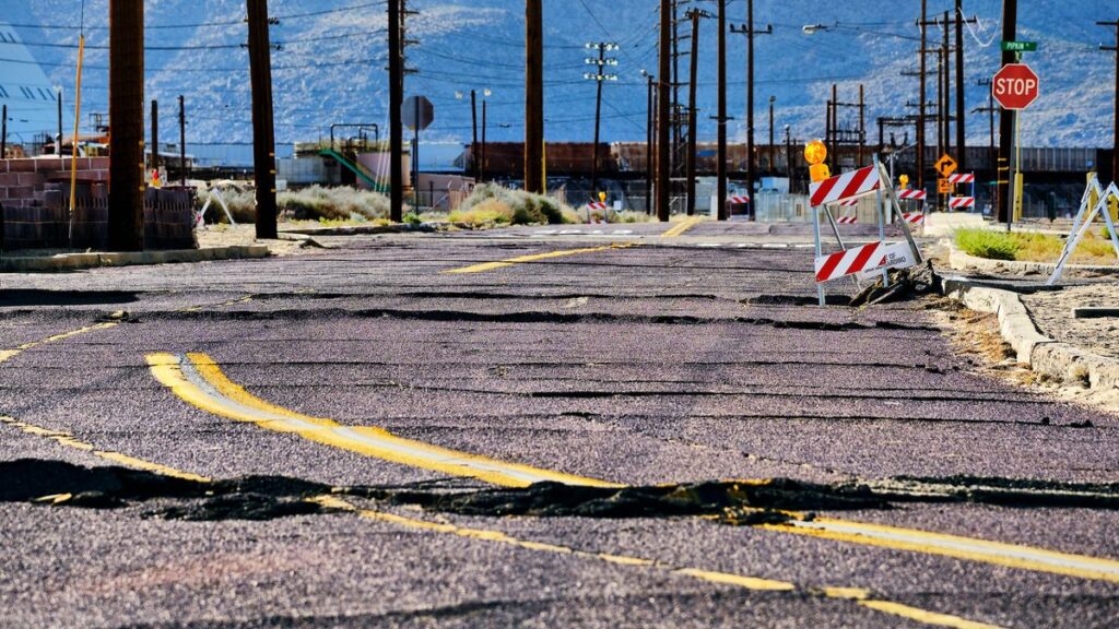 A photo showing a road torn up by an earthquake