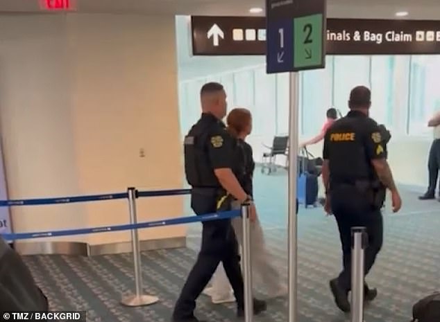 Other videos from after the plane landed in Orlando showed the woman being escorted out of the airport by police