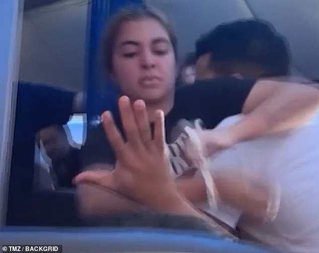 The video, filmed by another traveler, began after the crew tied zip ties around her wrists and she struggled with three of them.