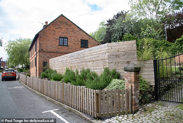 Mr Hubbard spent thousands of pounds clearing the garden and erecting a standard eight-foot fence to give his family some privacy and stop littering.