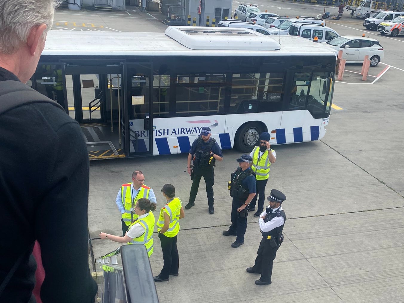 Bad airport: British Airways staff and airport police at the foot of the stairs of a BA Airbus A321 diverted from Gatwick to Heathrow