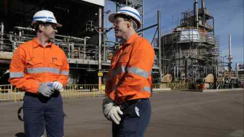 Workers outside the BHP Kwinana nickel refinery in Western Australia