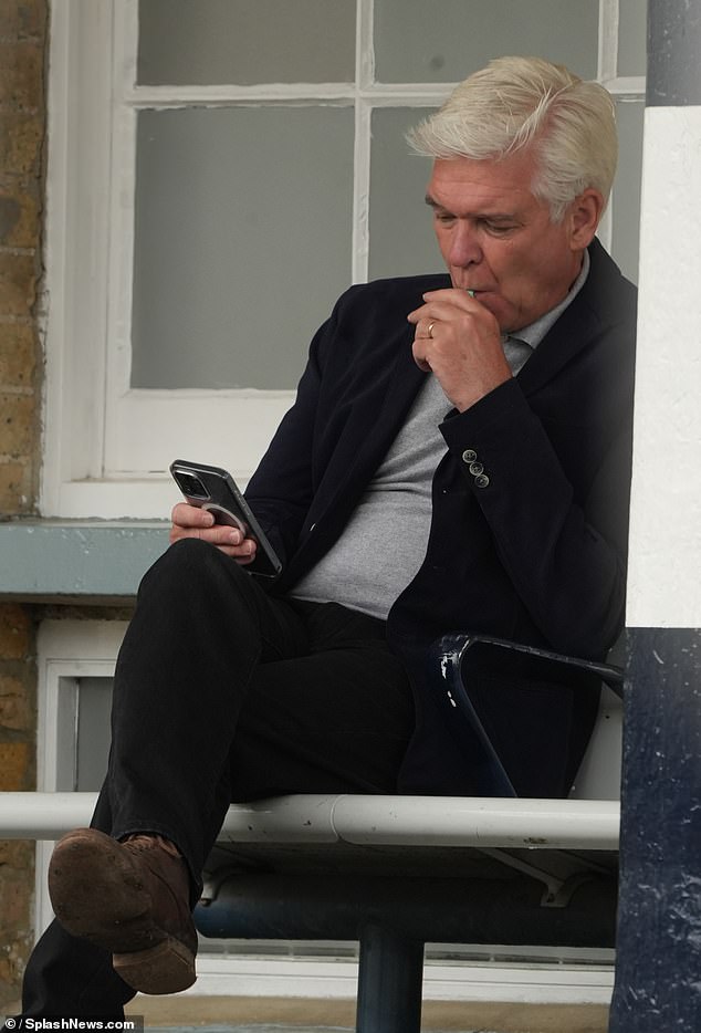 Phillip Schofield was spotted puffing on an e-cigarette at a west London train station - despite a ban on all forms of smoking