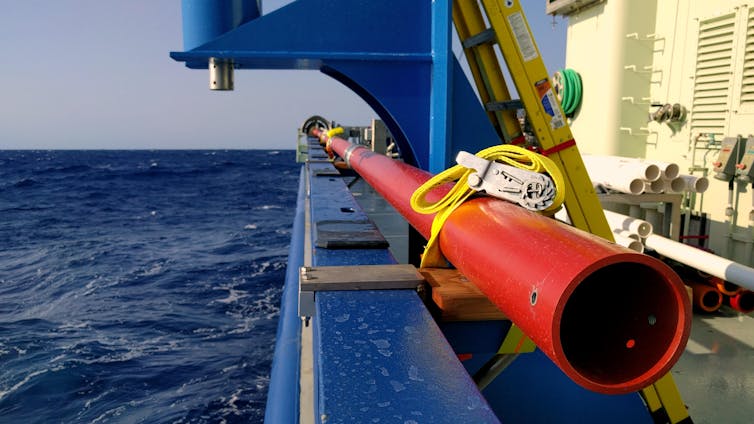 A red pipe on the side of the ship